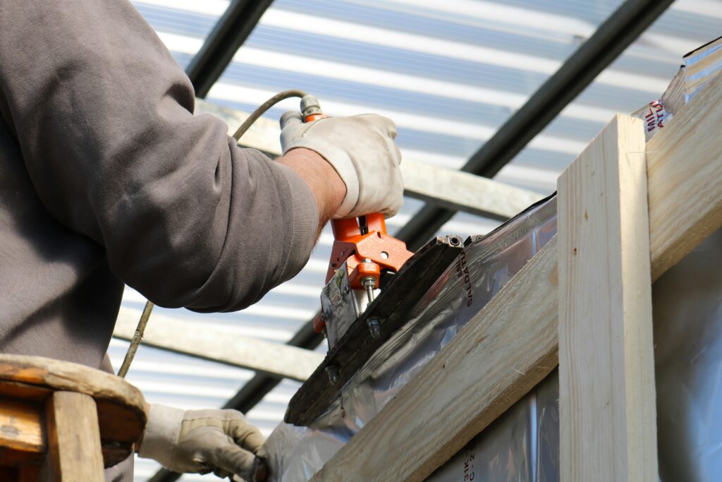 A construction worker using a power tool on a building project.